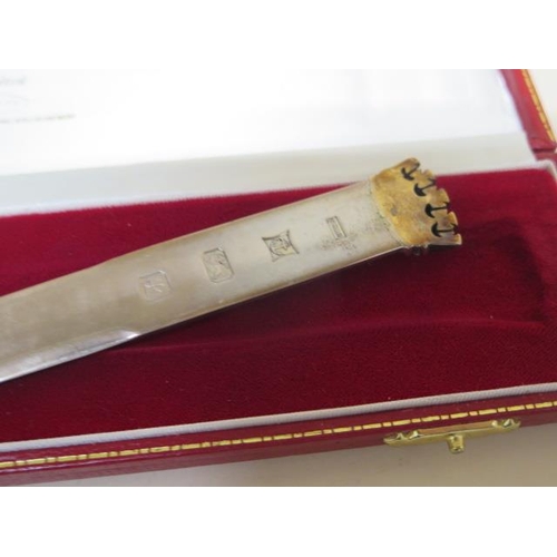 184 - A silver letter opener, boxed - length 24cm - five silver spoons and a nip - total weight approx 4.7... 