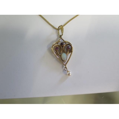 26 - A hallmarked yellow gold garnet, opal and pearl pendant on a hallmarked 9ct yellow gold chain - 50cm... 