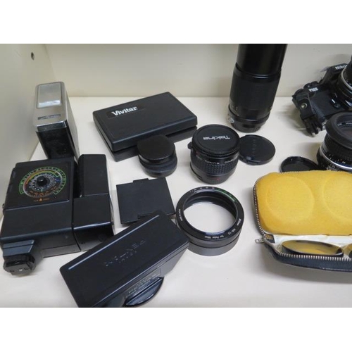 265 - A Nikon FM2 35mm camera, 4 lens Nikon Nikkor 50mm, Nikon Nikkor 135mm, Nikon Nikkor 28mm, Tokina 300... 