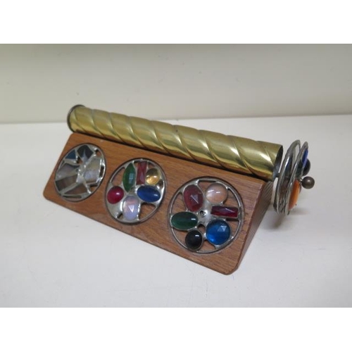 266 - An interesting brass kaleidoscope with four changeable heads on a wooden stand - Length 24cm