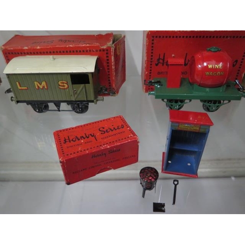 335 - A Hornby tin plate O gauge milk traffic van, RS655 brake van, single wine wagon, plate layers Hut, t... 