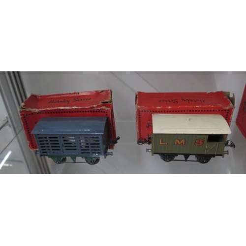 335 - A Hornby tin plate O gauge milk traffic van, RS655 brake van, single wine wagon, plate layers Hut, t... 