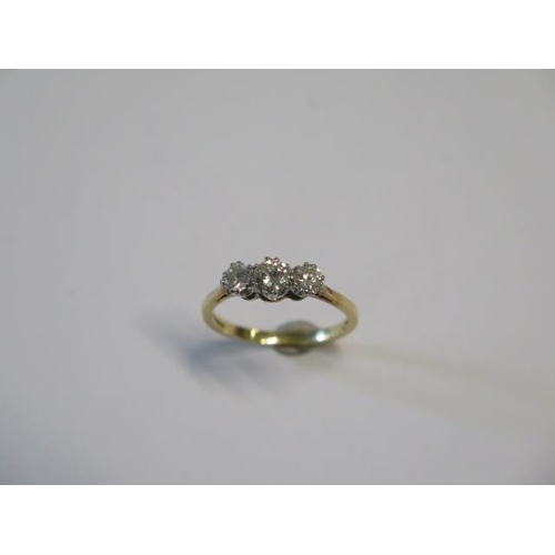 38 - A hallmarked 18ct yellow gold three stone diamond ring centre stone approx 0.30ct - diamond bright -... 