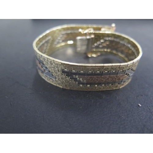 47 - A 9ct tricolour gold bracelet - Length 18.5cm closed x 1.5mm - approx weight 33.9 grams - in good co... 