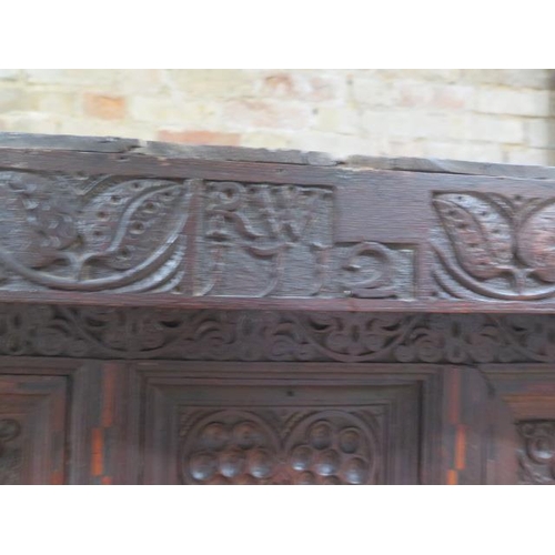 533 - An 18th century oak court cupboard with a carved two door top over two panel front drawers and two c... 