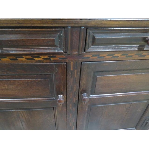 533 - An 18th century oak court cupboard with a carved two door top over two panel front drawers and two c... 