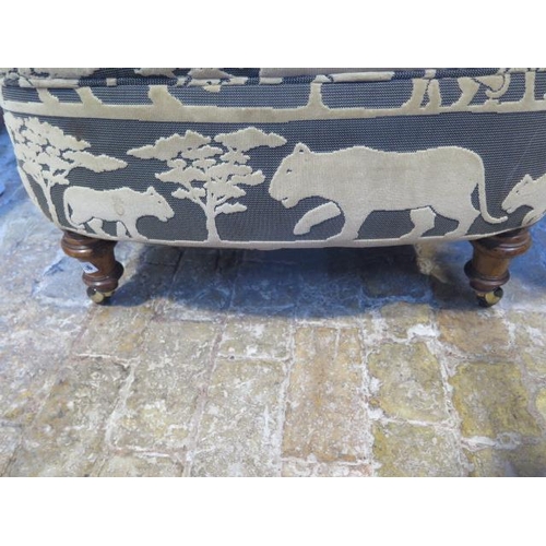 536 - A reupholstered Victorian armchair in a designer wild cat fabric - some wear to fabric