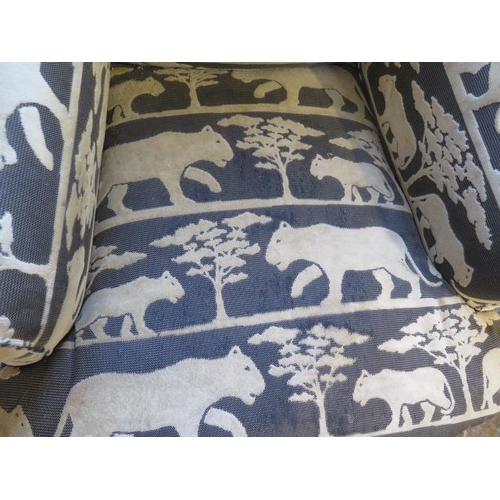 536 - A reupholstered Victorian armchair in a designer wild cat fabric - some wear to fabric