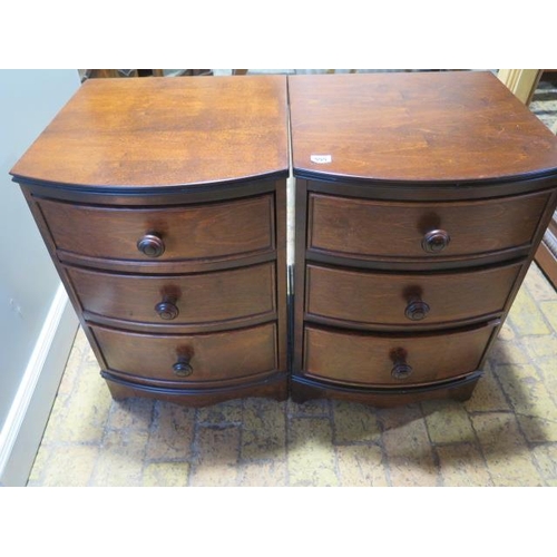 555 - A pair of bow fronted hardwood three drawer bedside chests - Height 66cm x 45cm x 45cm