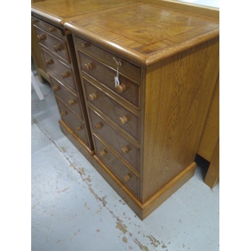 568 - A pair of burr oak bedside chests with a slide above four drawers made by a local craftsman to a hig... 