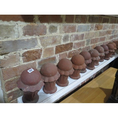 537 - A set of 11 terracotta finials - Height 24cm