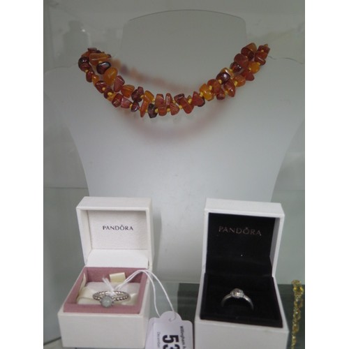 53 - An amber bead necklace - 90cm long and two Pandora silver rings, boxed - ring sizes K/L