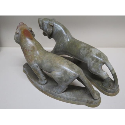 275 - A pair of green soapstone tigers - Height 18cm x Length 30cm