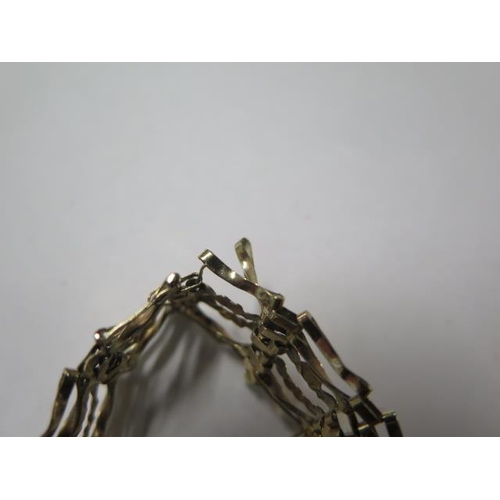 12 - A 9ct yellow gold gatelink bracelet, approx 7.3 grams, some bending, one link loose, clasp good
