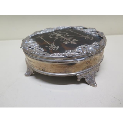 128 - A silver and tortoiseshell lidded jewellery box - 7cm tall x 16cm diameter - some wear/bending