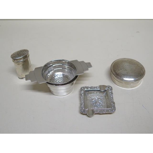 136 - A silver tea strainer and dish, silver mustard, silver pot, and a Continental silver ashtray - total... 