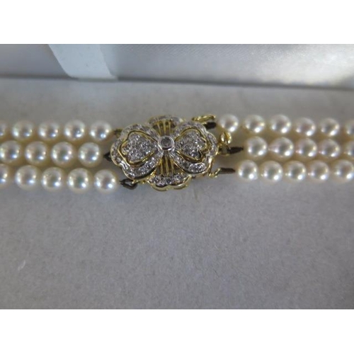 20 - A triple string of pearls with a S & S 14ct gold clasp, 40cm long, pearls approx 3mm
