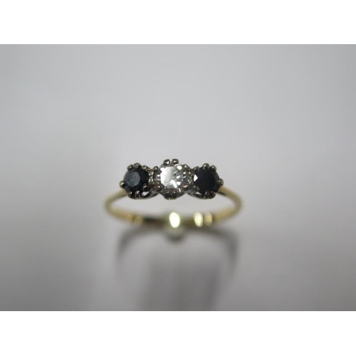 21 - A yellow gold diamond and sapphire three stone ring - tests to approx 18ct gold - ring size T - appr... 