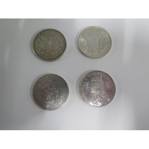 254 - Two silver Morgan Dollars 1878 and 1884, a George III silver Crown 1819 and a Victorian silver Crown... 