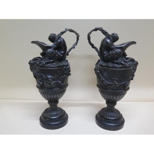 261 - A pair of  bronze Bacchanalian ewer type garnitures with good colour and patina, 44cm tall, some chi... 