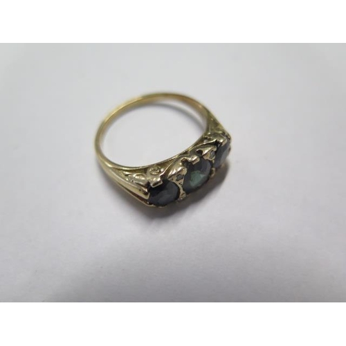 27 - A yellow gold three stone sapphire ring - tests to 9ct gold - ring size Q - approx weight 4.2 grams ... 