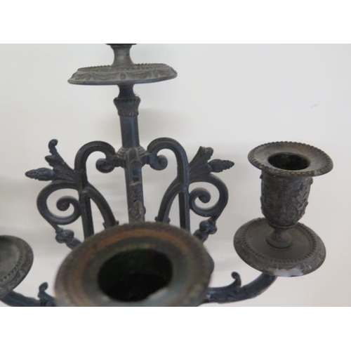 271 - A pair of ornate three branch spelter type candelabra, 71cm tall, one top damaged and one finial oth... 