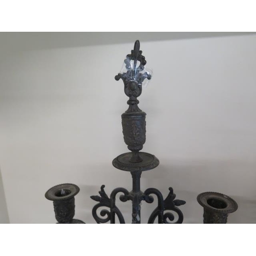 271 - A pair of ornate three branch spelter type candelabra, 71cm tall, one top damaged and one finial oth... 