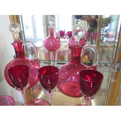 283 - Two cranberry glass jug decanters, six glasses and three ruby glasses - all good