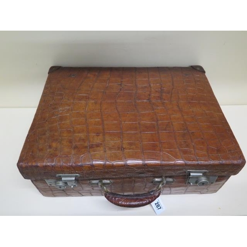 287 - A vintage Drew and Sons of London crocodile skin suitcase - with some old repairs, in polished condi... 