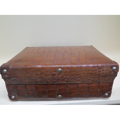 287 - A vintage Drew and Sons of London crocodile skin suitcase - with some old repairs, in polished condi... 