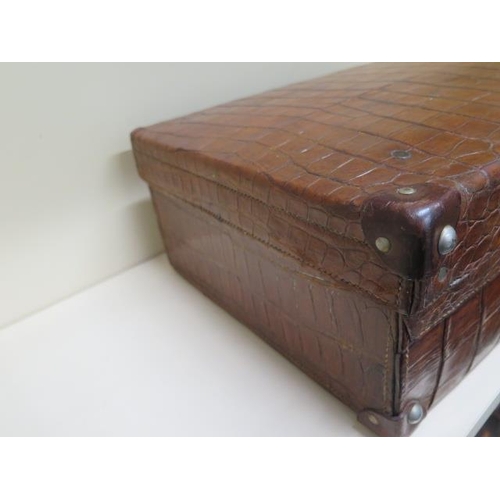 287 - A vintage Drew and Sons of London crocodile skin suitcase - with some old repairs, in polished condi... 