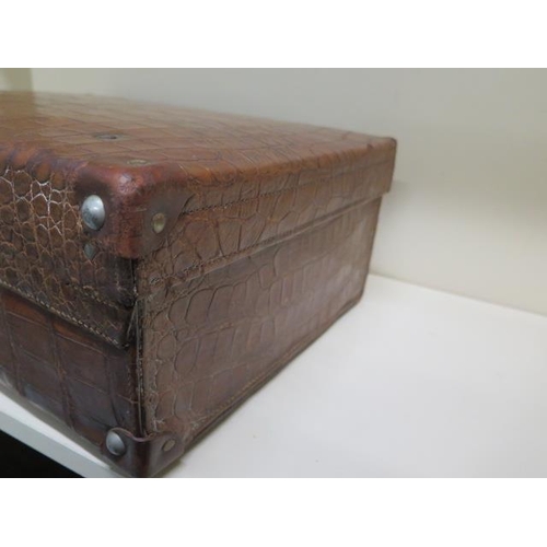 287 - A vintage Drew and Sons of London crocodile skin suitcase - with some old repairs, in polished condi... 