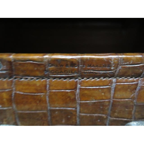 287 - A vintage Drew and Sons of London crocodile skin suitcase - with some old repairs, in polished condi... 