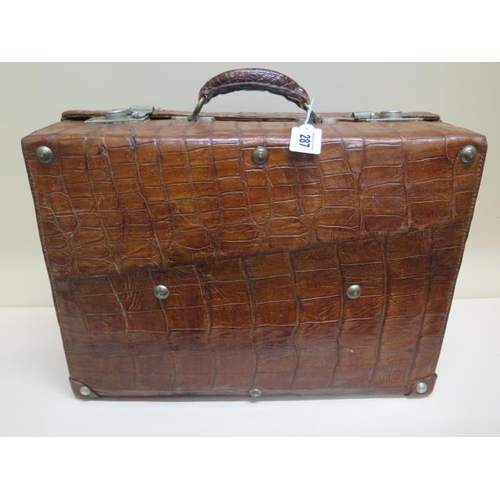 287 - A vintage Drew and Sons of London crocodile skin suitcase - with some old repairs, in polished condi... 