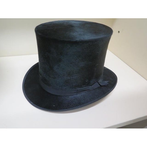 288 - A Victorian leather top hat box with a tall brushed silk top hat - approx size 7 and a collapsible o... 