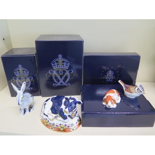 306 - Two boxed Royal Crown Derby paperweights, Starlight Hare, Freisian Cow and two boxed Members packs p... 