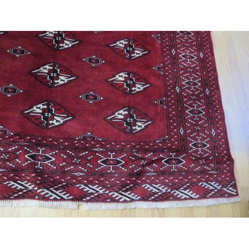 432 - A hand knotted woollen Turkman rug - 2.45m x 1.75m