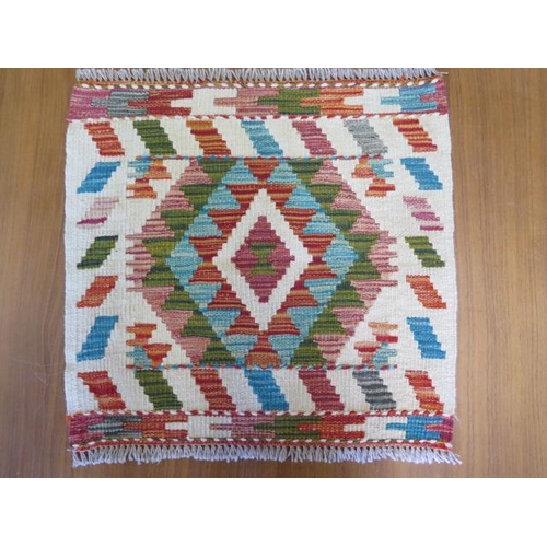 436 - A hand knotted woollen rug - 48cm x 51cm