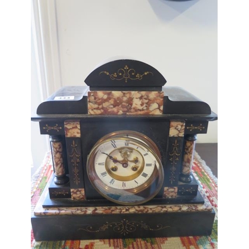 444 - A Victorian marble mantle and slate clock with exposed escapement, 33cm tall