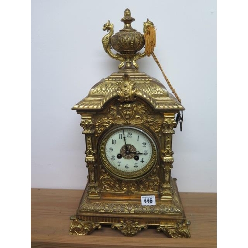 446 - A heavy brass ormolu striking mantle clock, 48cm tall, with a key and pendulum, appears overwound