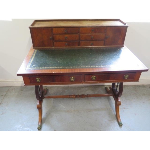 514 - A Regency style mahogany writing desk with an up stand having six small drawers and two small cupboa... 