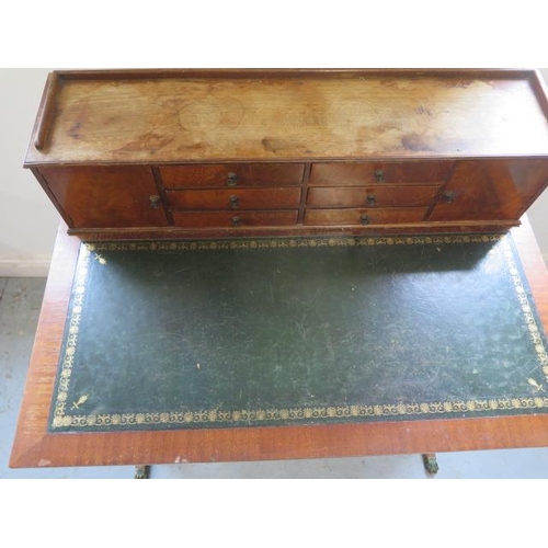 514 - A Regency style mahogany writing desk with an up stand having six small drawers and two small cupboa... 