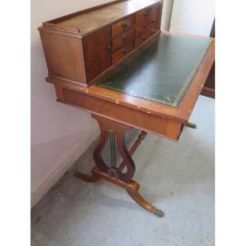 514 - A Regency style mahogany writing desk with an up stand having six small drawers and two small cupboa... 