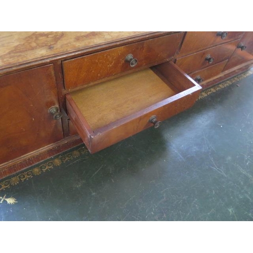 514 - A Regency style mahogany writing desk with an up stand having six small drawers and two small cupboa... 