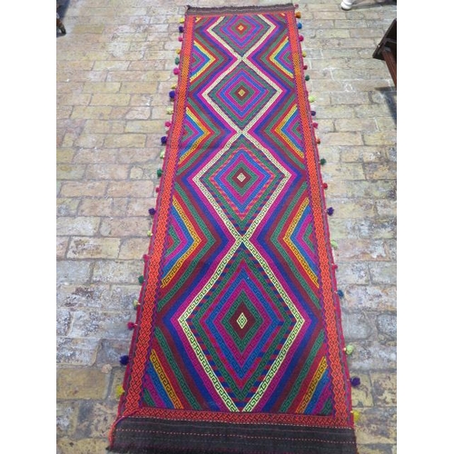 397 - A hand knotted woollen rug - 275cm x 77cm