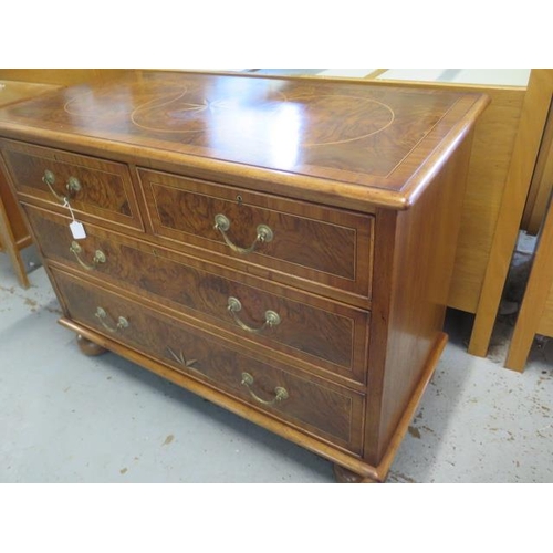 509 - A re veneered walnut star inlaid four drawer chest on bun feet - in good condition and colour - Heig... 