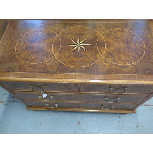 509 - A re veneered walnut star inlaid four drawer chest on bun feet - in good condition and colour - Heig... 