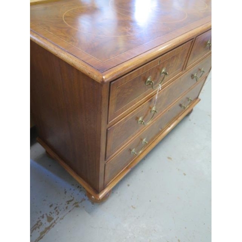 509 - A re veneered walnut star inlaid four drawer chest on bun feet - in good condition and colour - Heig... 