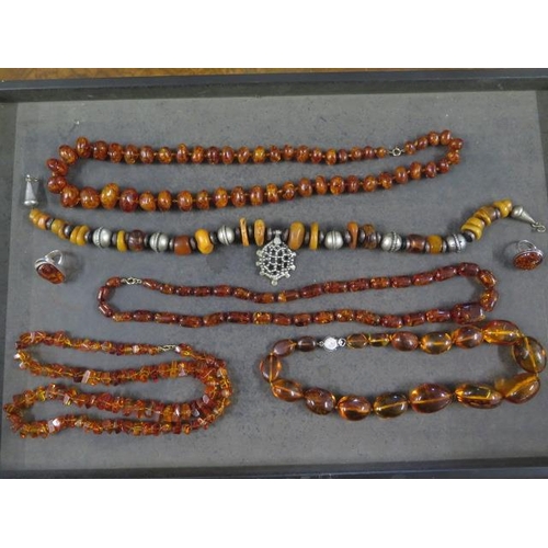 100 - A collection of five amber type and similar necklaces and two rings