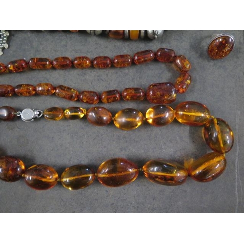 100 - A collection of five amber type and similar necklaces and two rings